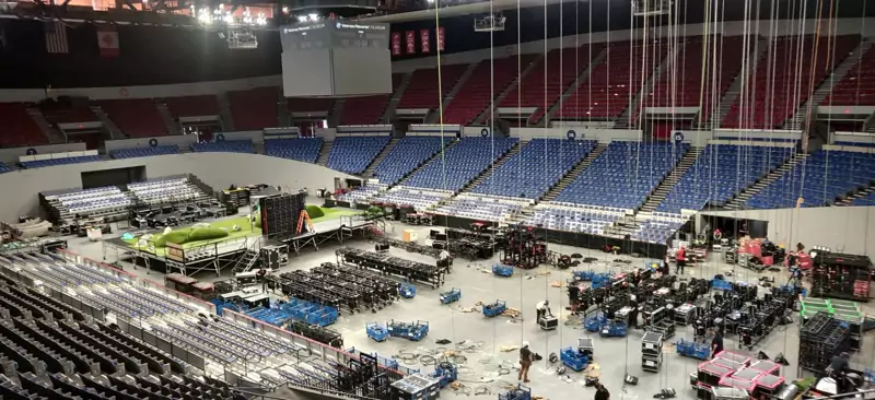 Arena floor during a concert load-in, with staging and production gear being set up
